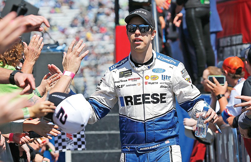 In this March 24, 2019, file photo, Brad Keselowski greets fans during driver introductions prior to the NASCAR Cup Series race at the Martinsville Speedway in Martinsville, Va.