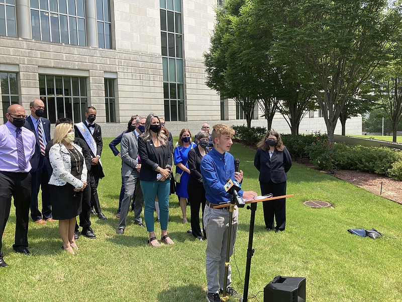 Dylan Brandt speaks at a news conference outside the federal courthouse in Little Rock, Ark., on Wednesday, July 21, 2021. Brandt, 15, has been receiving hormone treatments and is among several transgender youth who challenged a state law banning gender confirming care for trans minors. A federal judge on Wednesday blocked that law's enforcement.  (AP Photo/Andrew DeMillo)