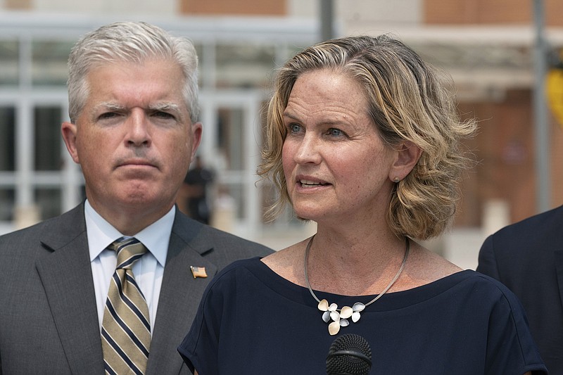 Nassau County Executive Laura Curran, right, speaks at a news conference to discuss a settlement in an opioid trial, Tuesday, July 20, 2021, in Central Islip, N.Y. Suffolk County Executive Steve Bellone is behind her. New York State reached an agreement Tuesday with the distribution companies AmerisourceBergen, Cardinal Health and McKesson to settle an ongoing trial. That deal alone would generate more than $1 billion to abate the damage done by opioids there. The trial is expected to continue, but the settlement leaves only three drug manufacturers as defendants. (AP Photo/Mark Lennihan)