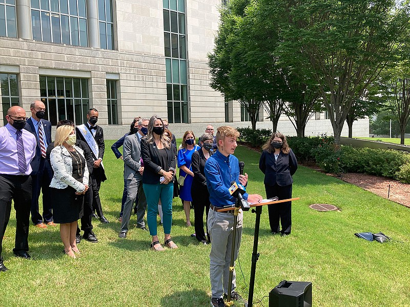 Dylan Brandt speaks at a news conference outside the federal courthouse in Little Rock, Ark., on Wednesday, July 21, 2021. Brandt, 15, has been receiving hormone treatments and is among several transgender youth who challenged a state law banning gender confirming care for trans minors. A federal judge on Wednesday blocked that law's enforcement.  (AP Photo/Andrew DeMillo)