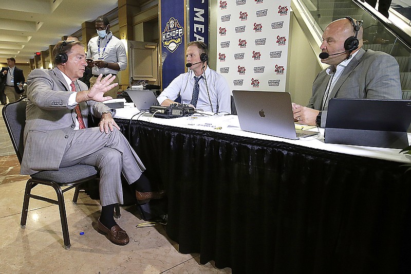 Alabama coach Nick Saban is interviewed Wednesday by former Alabama quarterback Greg McElroy and former Auburn player Cole Cubelic during SEC Media Days in Hoover, Ala.