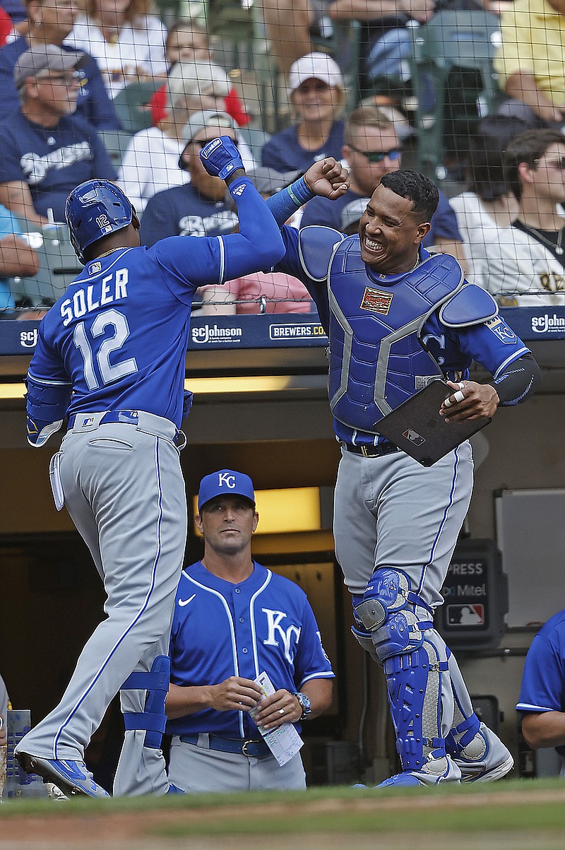 Jorge Soler celebrates with Salvador Perez after hitting a solo home run in the eighth inning of Wednesday's game against the Brewers in Milwaukee.