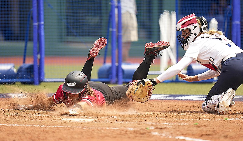 Canada's Joey Lye (left) is tagged by United States catcher Aubree Munro at home plate during Thursday's game at the 2020 Tokto Olympics in Fukushima, Japan.