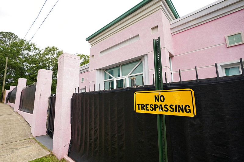 In this May 19, 2021, photo, the Jackson Women's Health Organization clinic, more commonly known as "The Pink House," is shrouded with a black tarp so that its clients may enter in privacy in Jackson, Miss.