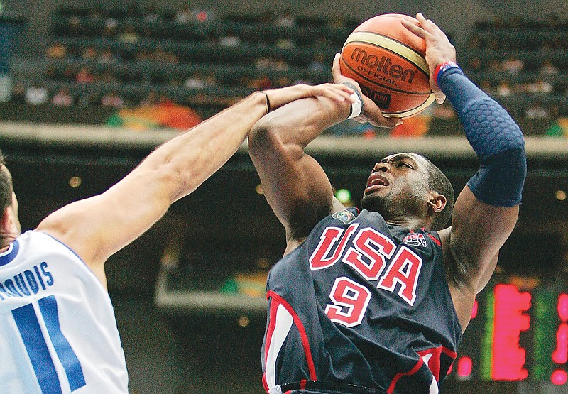 In this Sept. 1, 2006, file photo, Dwyane Wade of the United States is fouled by Greece's Dimos Dikoudis during the semifinals of the World Basketball Championships in Saitama, Japan.