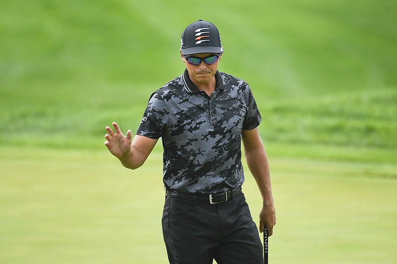 Rickie Fowler acknowledges the crowd after making a putt on the first hole during Thursday's first round of the 3M Open in Blaine, Minn.