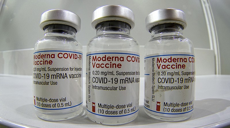 FILE - In this file photo dated Wednesday, Feb. 17, 2021, three vials of the Moderna COVID-19 Vaccine are pictured in a new coronavirus vaccination center at the 'Velodrom' (velodrome-stadium) in Berlin, Germany. The European Medicines Agency has recommended approving Moderna’s COVID-19 vaccine for children aged 12 to 17, the first time the shot has been authorized for people under 18. In a decision on Friday, July 23, 2021 the EU drug regulator said research in more than 3,700 children aged 12 to 17 showed that the Moderna vaccine — already given the OK for adults across Europe — produced a comparable antibody response. (AP Photo/Michael Sohn, File)