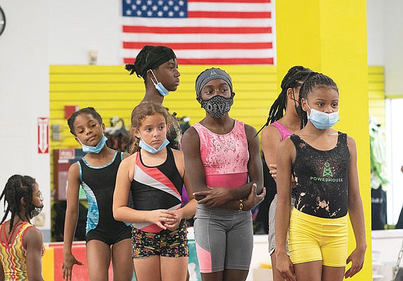 Girls wait in line to practice gymnastics Thursday at Power Moves Gymnastics and Fitness in Cedarhurst, N.Y.