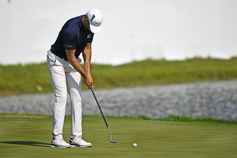 Cameron Tringale makes his final putt on the 18th hole to take the lead at 12-under par during Saturday's third round of the 3M Open in Blaine, Minn.