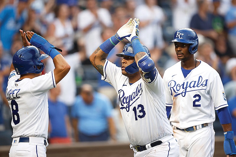 Salvador Perez is congratulated by Royals teammates Nicky Lopez (left) and Michael A. Taylor after hitting a three-run home run during the fifth inning of Saturday night's game against the Tigers at Kauffman Stadium in Kansas City.