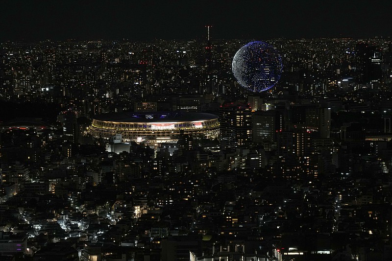 FILE - In this July 23, 2021, file photo, drones fly over the National Stadium during the opening ceremony of 2020 Tokyo Olympics is seen from Shibuya Sky observation deck in Tokyo, Japan. (AP Photo/Eugene Hoshiko, File)