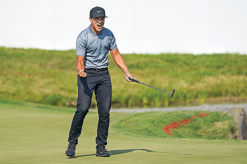 Cameron Champ celebrates after sinking a putt on the 18th hole Sunday to win the 3M Open in Blaine, Minn.