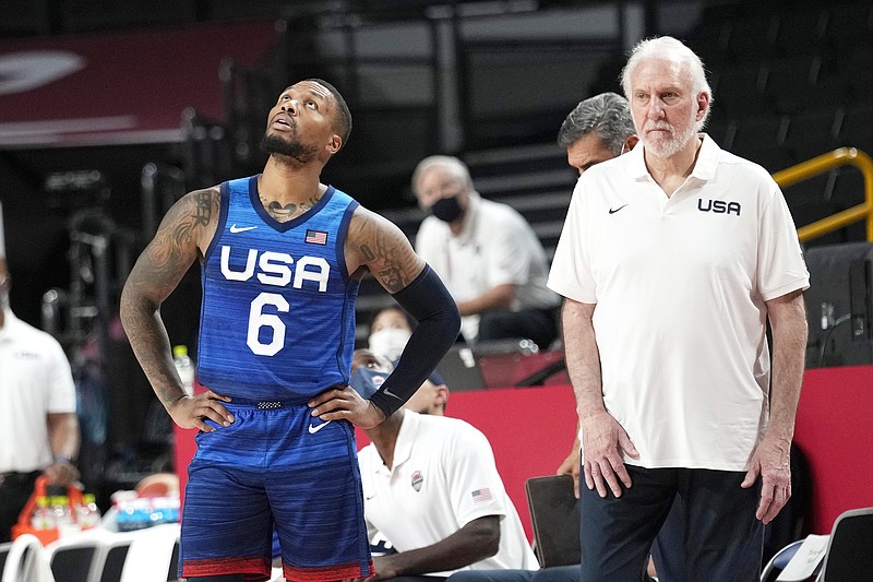 U.S. guard Damian Lillard and coach Gregg Popovich wait for a replay to decide possession of the ball during their loss to France in Sunday's preliminary round game at the 2020 Summer Olympics in Saitama, Japan.