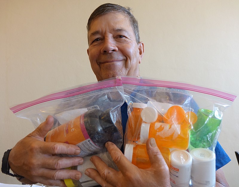 Dr. Joe d'Natale of Linden is holding plastic bags of assorted empty pill bottles. Your mystery challenge is to explain why. Your hint is that he is a member of the Lions Club which is why and where the pill containers are being collected. What for? That is your challenge. Return next week for the answer.
