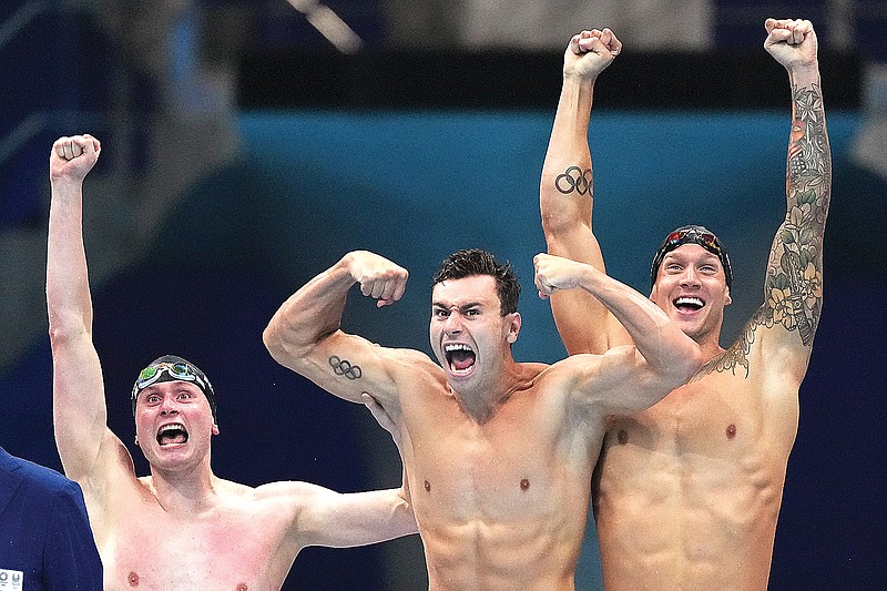 (From left) Bowen Becker, Blake Pieroni and Caeleb Dressel celebrate Monday after winning the gold medal for the U.S. in the men's 4x100-meter freestyle relay at the 2020 Summer Olympics in Tokyo.