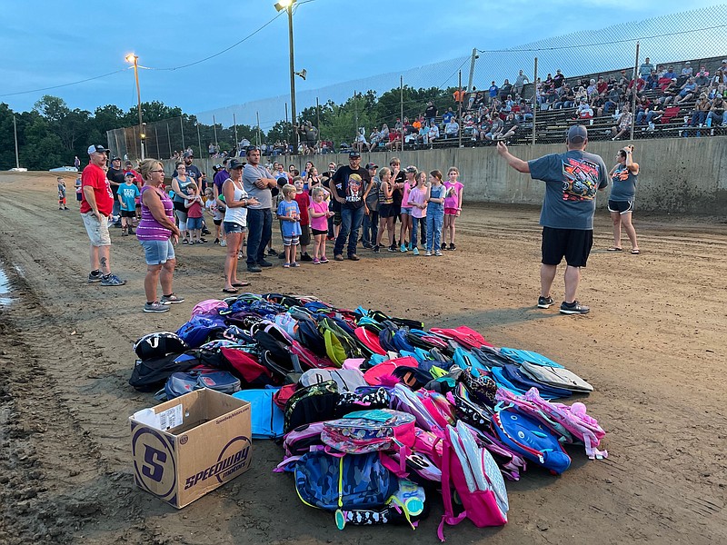 <p>Democrat photo/Kaden Quinn</p><p>Children wait patiently to grab their backpacks at Double-X Speedway’s “Racing Back to School” night. The event, which started in 2019 and made its return this year, provides children with free backpacks and other school supplies in advance of the start of school.</p>