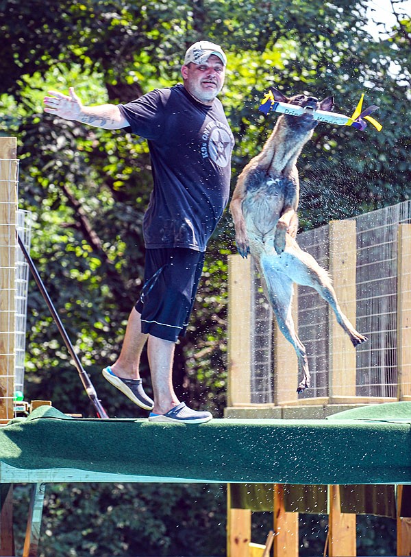 Jason Howe of K9's on the Front Line and Smokin' Guns Working Dog Club will be opening the pool and deck this weekend at his Holt Summit house for dock diving, a sport in which dogs catch a bumper in mid air and compete for distance. To demonstrate, Howe took Kineo, his 18-month-old Belgian Malinois, to the dock to show how the sport is performed.