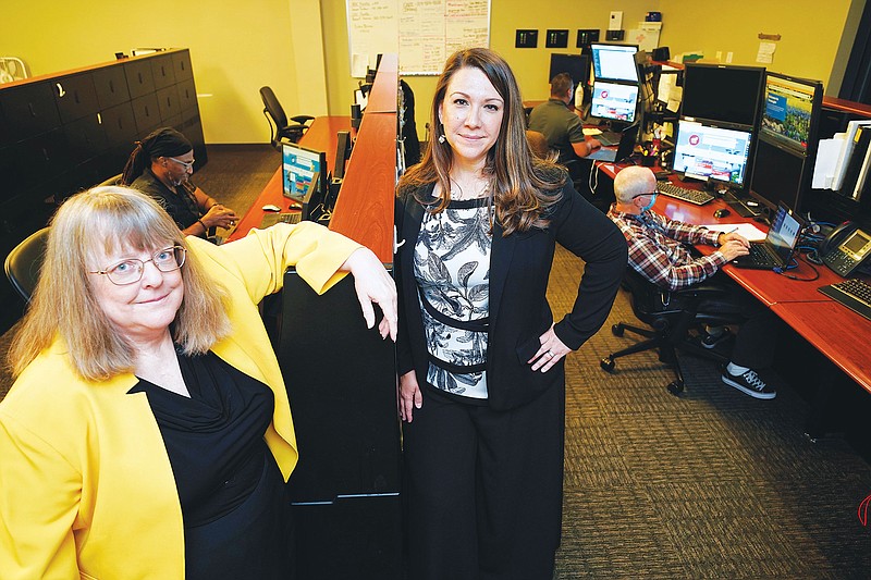 In this July 19, 2021, photo Amanda Crawford, right, and Nancy Rainosek, left, pose for a photo inside the state's Information Resources Command Center in Austin, Texas. (AP Photo/Chuck Burton)
