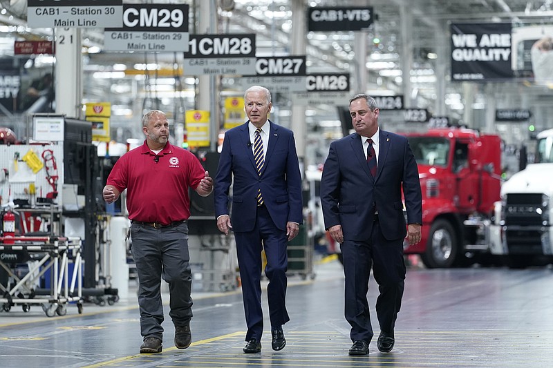 President Joe Biden walks with Mack Trucks President Martin Weissburg, right, and UAW Local 677 Shop Chairman Kevin Fronheiser, left, during a tour of the Lehigh Valley operations facility for Mack Trucks in Macungie, Pa., Wednesday, July 28, 2021. During his visit, he will advocate for government investments and clean energy as ways to strengthen U.S. manufacturing. (AP Photo/Susan Walsh)