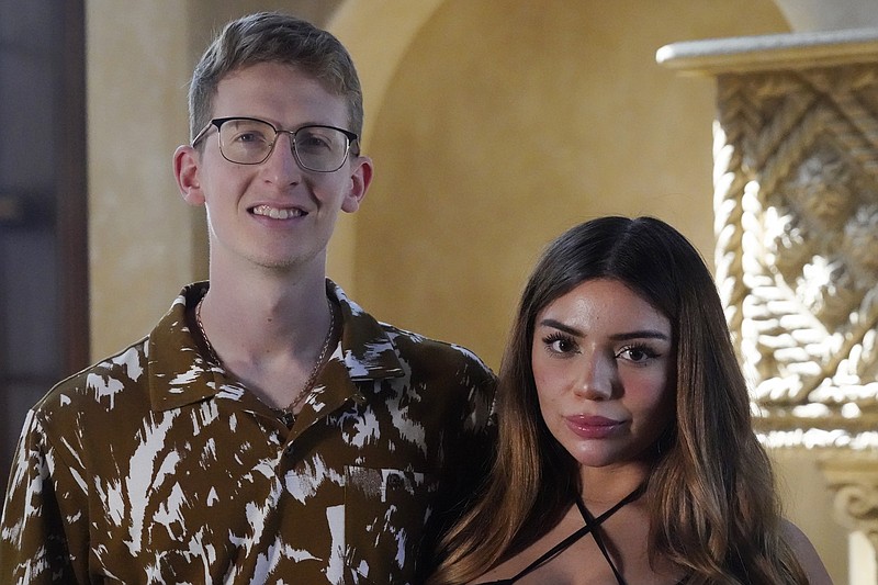 William Goodall, and Katiana Kay, his partner in their CBD online shop Bay Smokes, pose for a photo, Thursday, July 22, 2021, in Sunny Isles Beach, Fla. The two began selling delta-8 products in December with delta-8 quickly becoming a main source of revenue. The chemical, called delta-8 THC, is billed as producing a milder high than the better known delta-9 THC, and delta-8 is often marketed as being legal even where marijuana is not. (AP Photo/Wilfredo Lee)