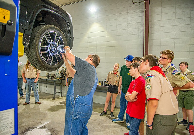 A group of BSA Scouts learn about checking a vehicle's suspension and brakes while earning the Automotive Maintenance merit badge at the 20th Annual Linn Merit Badge University on Saturday.  The event is presented by Scouts BSA Troop 17 in partnerhsip with Linn State Technical College, offering 39 merit badge class options to 400 Scouts from 131 Scouts BSA Troops across 8 states.  (Ken Barnes/News Tribune)