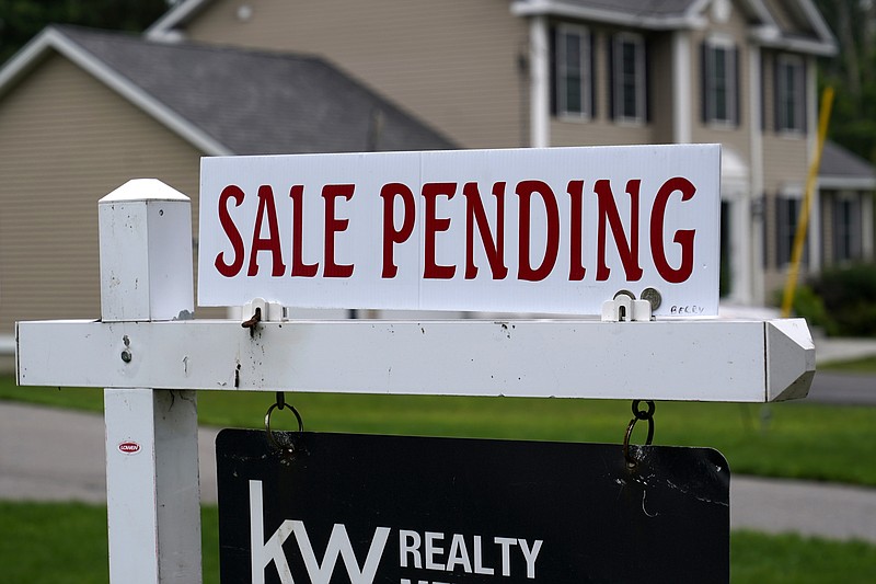 FILE - A "sale pending" sign is posted outside a single family home in a residential neighborhood, Wednesday, July 14, 2021, in Derry, N.H. Mortgage rates were mixed last week. The key 30-year home loan remained below 3% for the fifth straight week amid continued concern over the surging delta coronavirus variant and the progress of economic recovery. Mortgage buyer Freddie Mac reports that the average for the 30-year mortgage edged up to 2.80% from 2.78% last week.  (AP Photo/Charles Krupa, File)