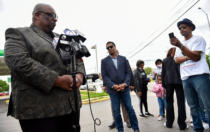 Darron LaMonte Edwards, left, of United Believers Community Church, talks to the media Tuesday, June 1, 2021, after the family of Malcolm Johnson provided a video of the fatal shooting by police of Johnson at the BP gas station at E. 63rd and Prospect Avenue in March. Faith leaders called it an "execution." Rev. Emanuel Cleaver III of St. James United Methodist Church, center, also spoke. (Jill Toyoshiba/The Kansas City Star via AP)