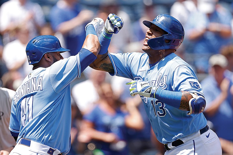 Salvador Perez (right) is congratulated by Royals teammate Carlos Santana after hitting a two-run home run during the first inning of Thursday afternoon's game against the White Sox at Kauffman Stadium.