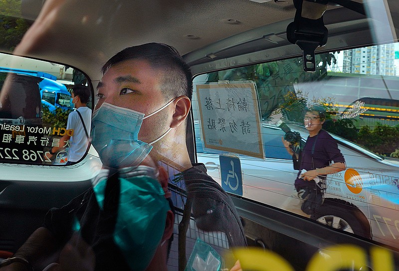 In this Monday, July 6, 2020, file photo, Tong Ying-kit, 23 years old, arrives at a court for the violation of the new security law after carrying a flag reading "Liberate Hong Kong, Revolution of our times" during a protest in Hong Kong. Tong has been sentenced to nine years in prison in the closely watched first case under Hong Kong's national security law as Beijing tightens control over the territory. (AP Photo/Vincent Yu, File)