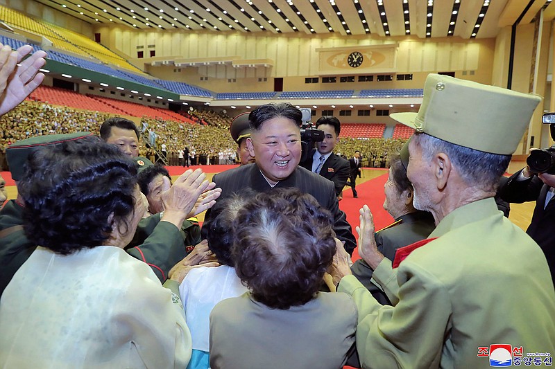 In this photo provided by the North Korean government, North Korean leader Kim Jong Un, center, is welcomed by participants of a veteran conference in Pyongyang, North Korea, Thursday, July 29, 2021. North Korea said Friday, July 30, 2021 that Kim called for stronger capability to cope with any foreign provocation as he met with military officers ahead of annual drills next month between South Korea and the United States that Pyongyang views as an invasion rehearsal. Independent journalists were not given access to cover the event depicted in this image distributed by the North Korean government. The content of this image is as provided and cannot be independently verified. Korean language watermark on image as provided by source reads: "KCNA" which is the abbreviation for Korean Central News Agency. (Korean Central News Agency/Korea News Service via AP)