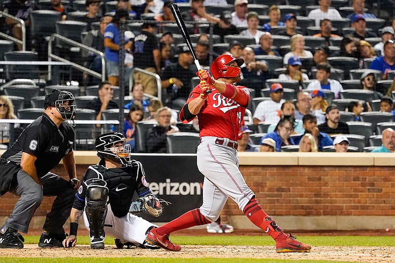 Cincinnati Reds' Joey Votto, right, watches his solo home run in the sixth inning of the baseball game against the New York Mets, Friday, July 30, 2021, in New York. (AP Photo/Mary Altaffer)