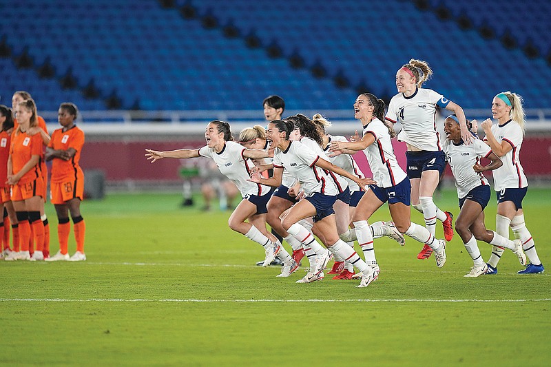 United States players celebrate after defeating the Netherlands in a penalty shootout Friday in a women's quarterfinal match at the 2020 Summer Olympics in Yokohama, Japan.