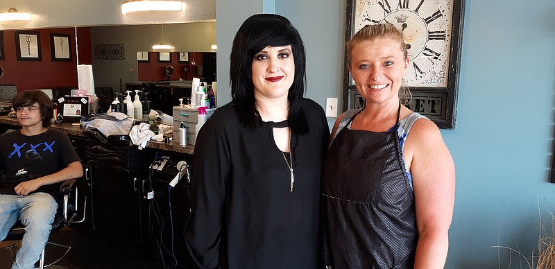 Jasselyn Foster, manager, greets customers during Saturday's grand opening of West Side Cuts on West 7th Street, along with veteran stylist, Kaitlyn Burns. The new place was redesigned for a more modern look. They are hiring stylists.