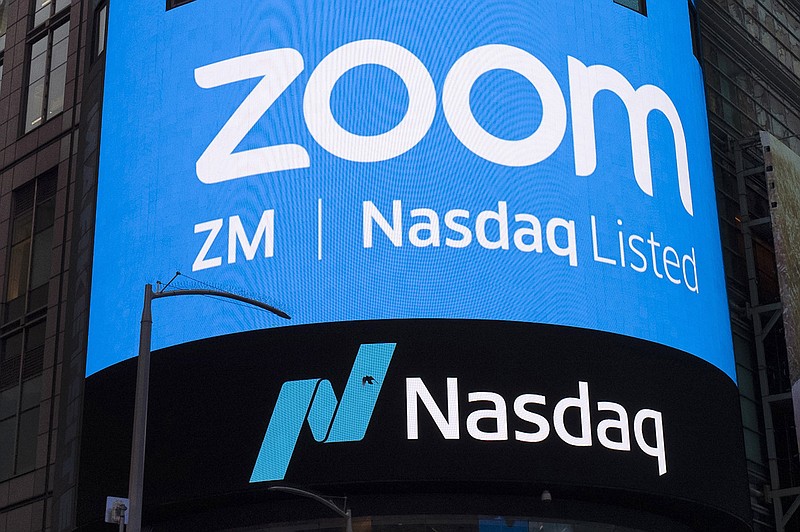 FILE - This April 18, 2019, file photo shows a sign for Zoom Video Communications ahead of their Nasdaq IPO in New York. Zoom has agreed to pay $85 million, Monday, Aug. 2, 2021,  to settle a lawsuit alleging allegations its videoconferencing service’s weak privacy controls opened too many peepholes into its users’ personal information and made it too easy to disrupt their meetings during the early stages of the pandemic.   (AP Photo/Mark Lennihan, File)