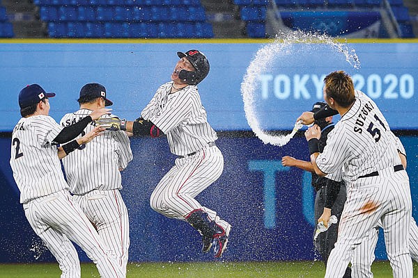 Japan's Takuya Kai (center) and teammates celebrates after Monday's win against the United States at the 2020 Summer Olympics in Yokohama, Japan.