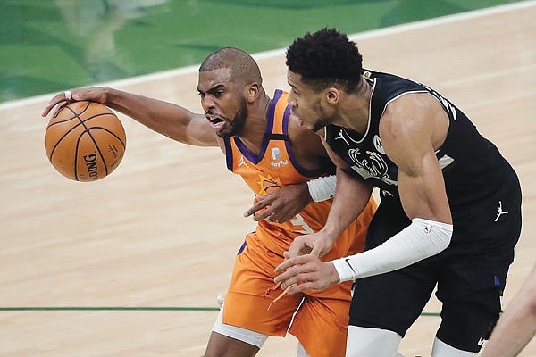 In this July 20 file photo, Suns guard Chris Paul drives to the basket against Bucks forward Giannis Antetokounmpo in Game 6 of the NBA Finals in Milwaukee.