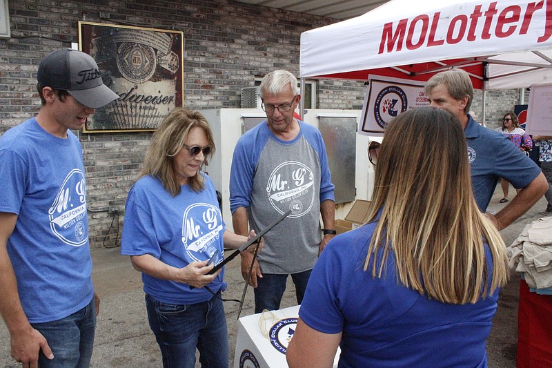 <p>Democrat photo/Austin Hornbostel</p><p style="text-align:right;">Representatives with the Missouri Lottery present the Gerhart family with a framed certificate and gift box in honor of their induction to the Million Dollar Club.</p>