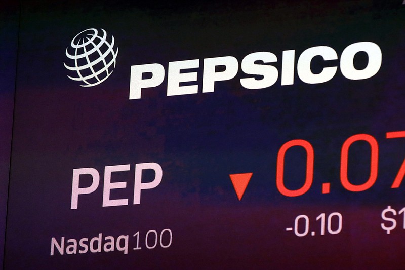 FILE - The symbol for Pepsico appears on a screen at the Nasdaq MarketSite in New York, in this Tuesday Oct. 1, 2019, file photo. PepsiCo will sell Tropicana and other juices to a private equity firm in exchange for pretax proceeds of $3.3 billion.PepsiCo will have a 39% non-controlling stake in a newly formed joint venture in the deal with PAI Partners .(AP Photo/Richard Drew, File)