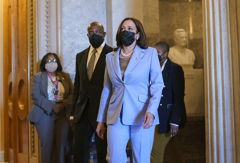 Vice President Kamala Harris, joined by Sen. Raphael Warnock, D-Ga., left, departs the Senate as lawmakers work to advance the $1 trillion bipartisan infrastructure bill, at the Capitol in Washington, Monday, Aug. 2, 2021. The 2,700-page bill includes new expenditures on roads, bridges, water pipes broadband and other projects, plus cyber security. (AP Photo/J. Scott Applewhite)