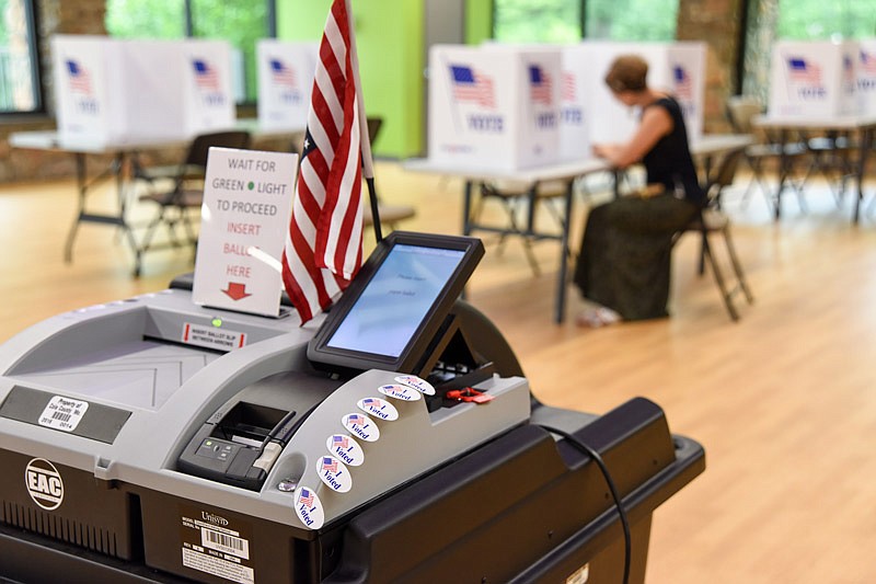 Rachelle Gilbert, shown in background at table, was the 31st Jefferson City voter to cast her ballot Tuesday, Aug. 3, 2021, at the McClung Park polling location. 