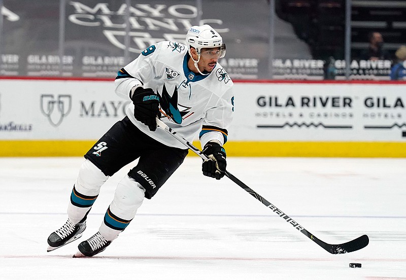 In this March 26, 2021, file photo, San Jose Sharks left wing Evander Kane moves the puck during the team's NHL hockey game against the Arizona Coyotes in Glendale, Ariz.T he NHL says it will investigate an allegation made by Kane's wife that he bets on his own games and has intentionally tried to lose for gambling profit. (AP Photo/Rick Scuteri, File)