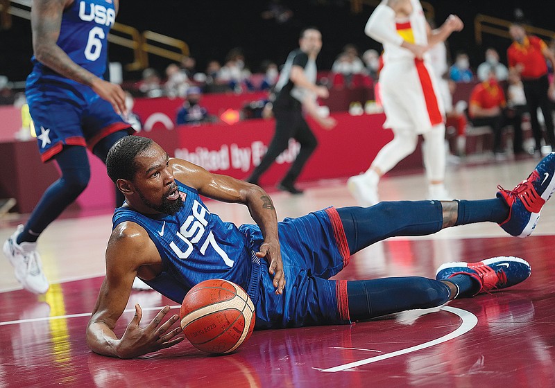 Kevin Durant of the United States gets control of the ball after falling to the court during Tuesday's game against Spain at the 2020 Summer Olympics in Saitama, Japan.