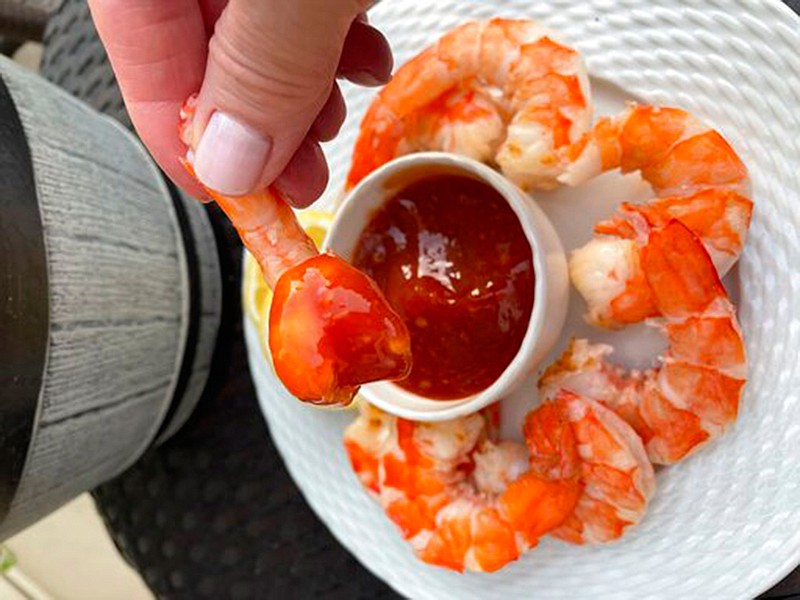 This May 19, 2021, photo provided by Elizabeth Karmel shows a grilled shrimp cocktail with Bloody Mary sauce in Alexandria, Va. (Elizabeth Karmel via AP)