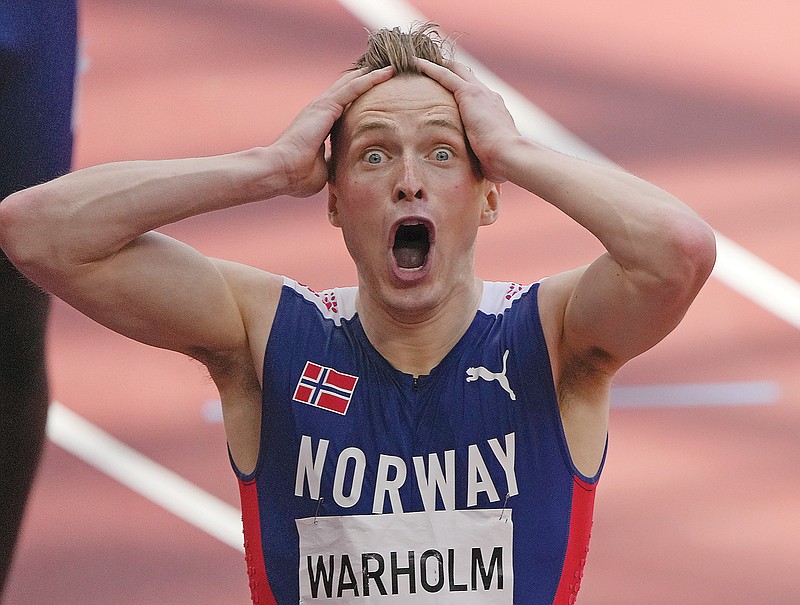Karsten Warholm of Norway celebrates after he won the gold medal Tuesday in the men's 400-meter hurdles at the 2020 Summer Olympics in Tokyo.