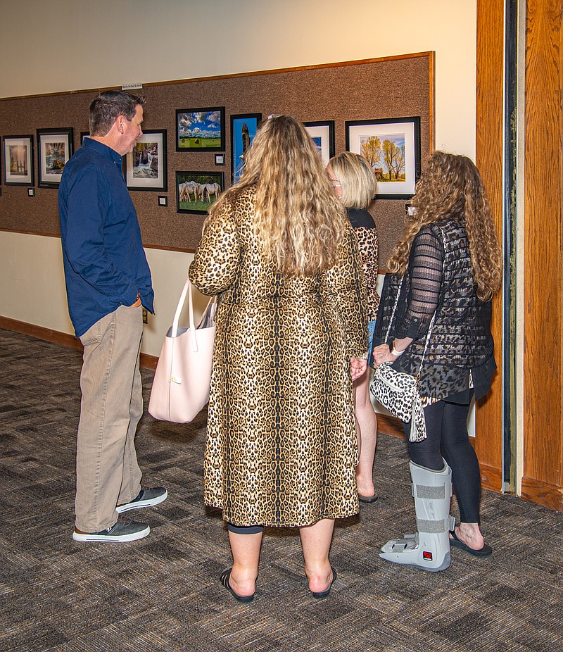 Photographer and Jefferson City area native Steven Strauch talks with guests at a reception for his "Across Our WIde Missouri" Bicentennial Exhibit at Missouri River Regional LIbrary Saturday.  (Ken Barnes/News Tribune)