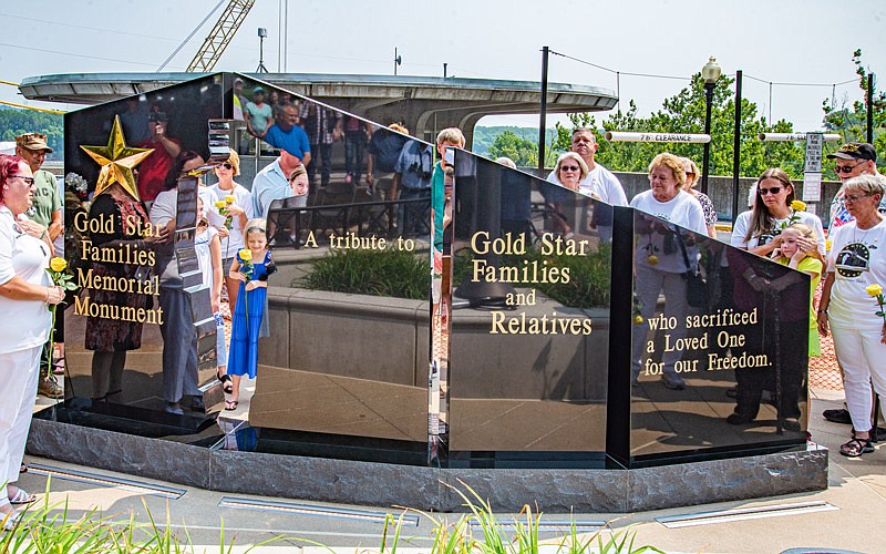 The Gold Star Families Memorial Monument, surrounded by Gold Star families, was unveiled Saturday on the North side of the Capitol.  (Ken Barnes/News Tribune)