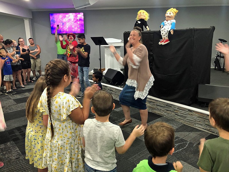 Gerry Tritz/News TribuneRachel Hickman gets the kids energized during a puppet show at Landmark Church's second annual Back-to-School Block Party Sunday morning.