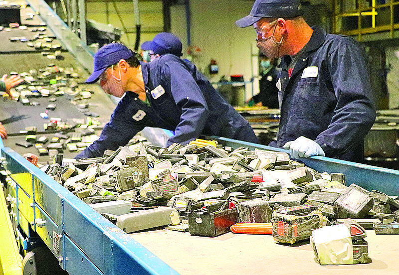 Li-Cycle employees feed lithium-ion batteries into a shredder at a Kingston, Ontario, Canada facility. The Canadian battery recycling company partnered with General Motors Co. in May to recycle scrap metal from battery manufacturing.  