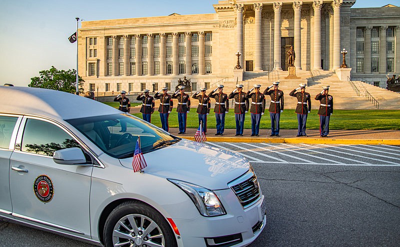 A Marine Corps honor guard salutes fallen Marine Corporal Dalton Pierson on Wednesday, Aug. 11, 2021, as the motorcade bringing him home stopped at the Capitol.  (Ken Barnes/News Tribune)