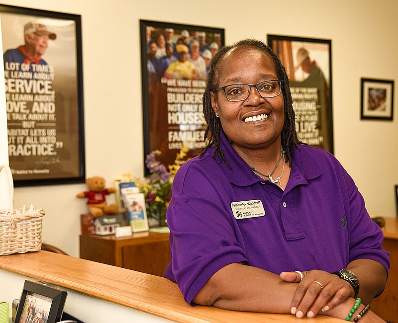 Kimberley Woodruff poses at the River City Habitat for Humanity office on Creek Trail Drive in Jefferson City, where she serves as the volunteer coordinator. (Julie Smith/News Tribune)